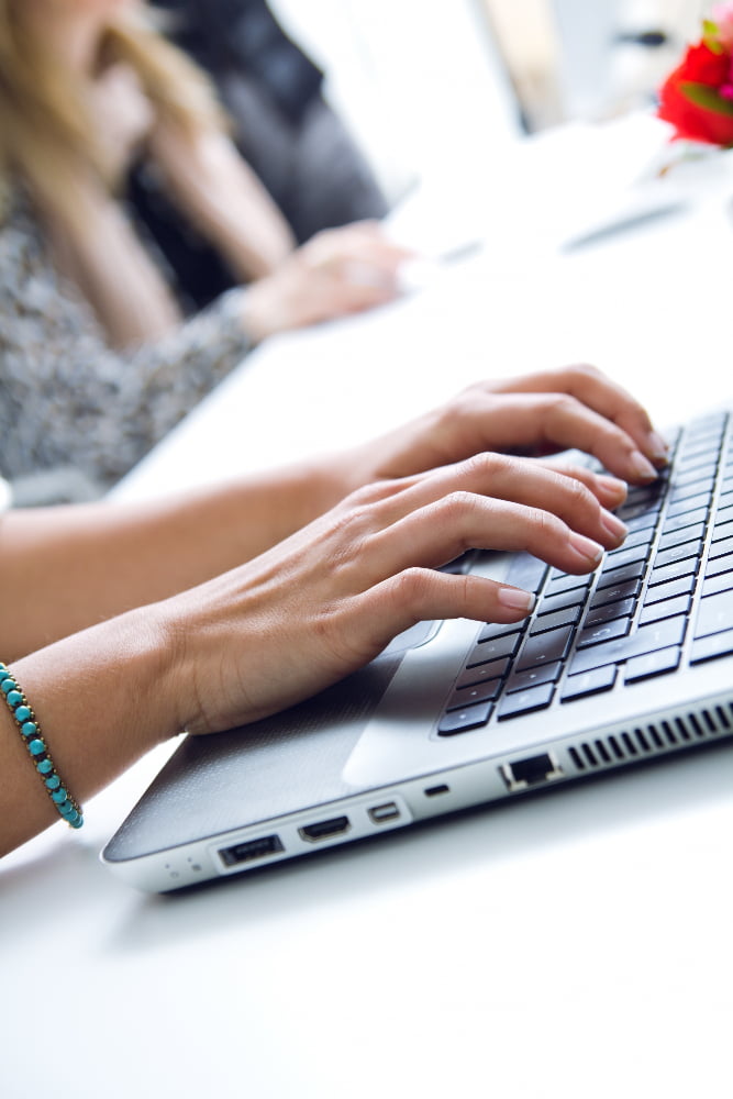 A hand using a computer keyboard